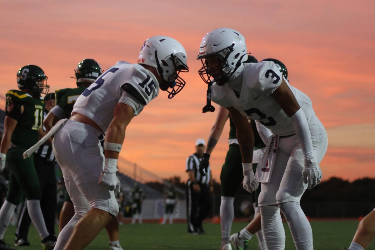 Seniors Andy Watts and Desmon Williams celebrate after a play.