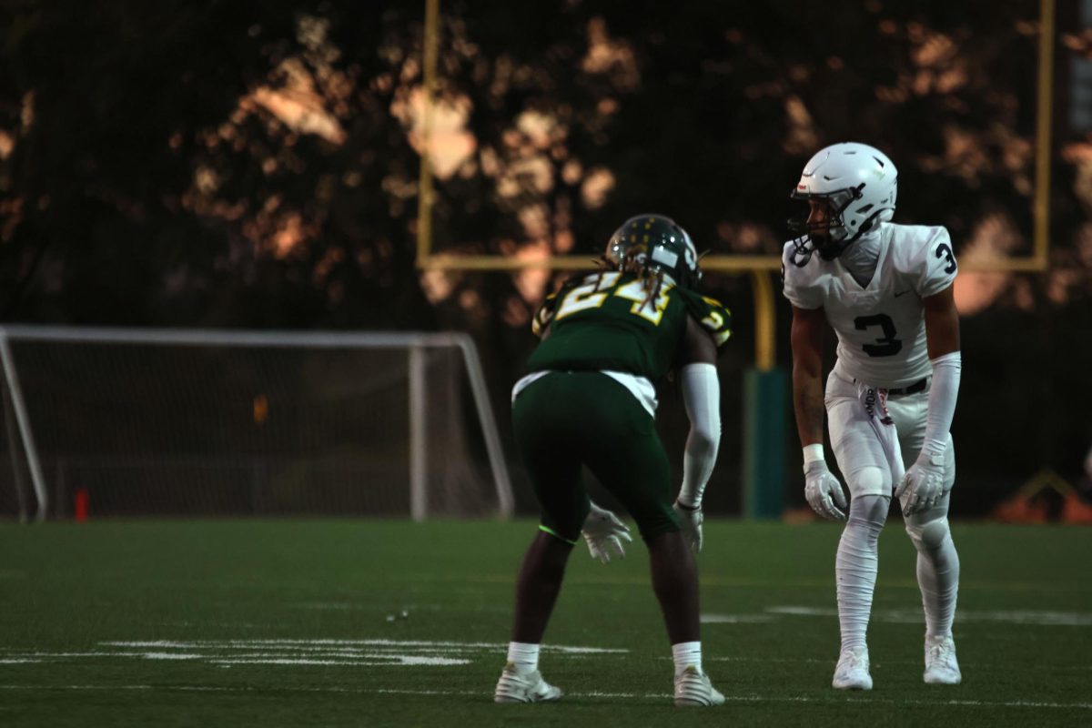 Facing his opponent, Senior Desmon Williams gets ready to block him.