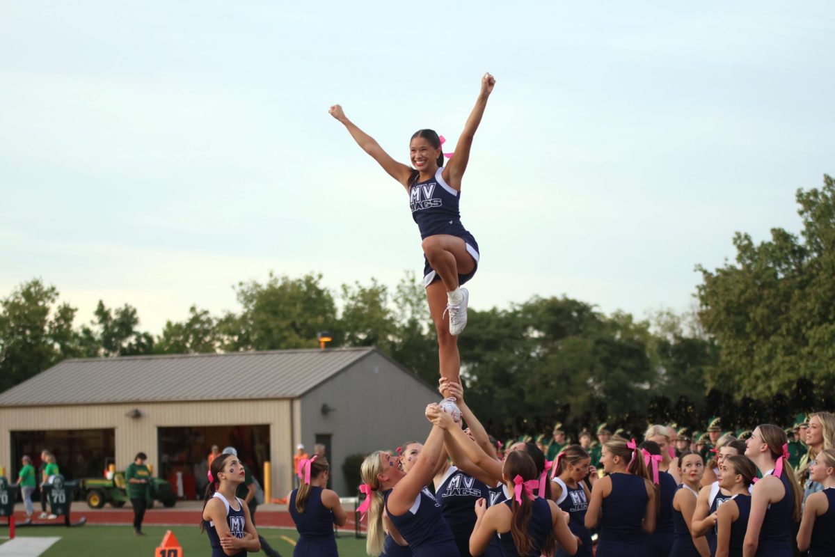 Smiling big, senior Emerson Jones gets lifted into the air.