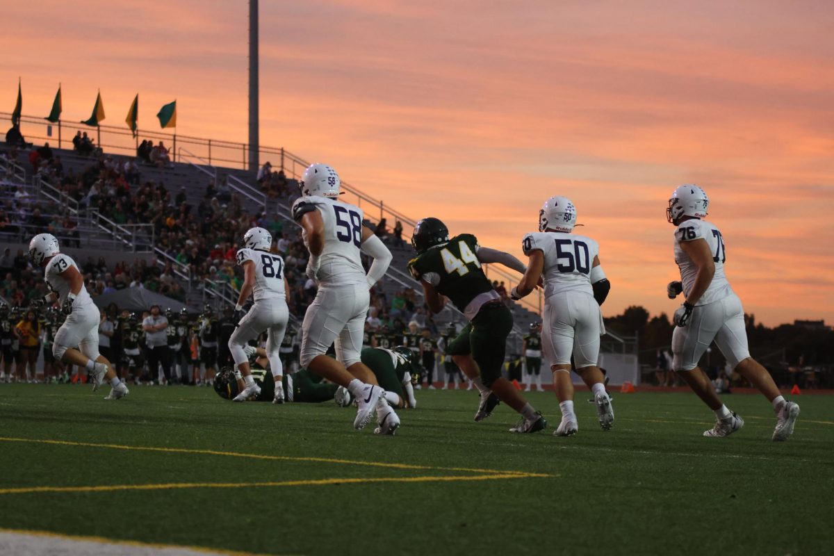 Seniors Abe Shaffer, Zach Zaldivar, and CJ Tilley run to defend their teammates.