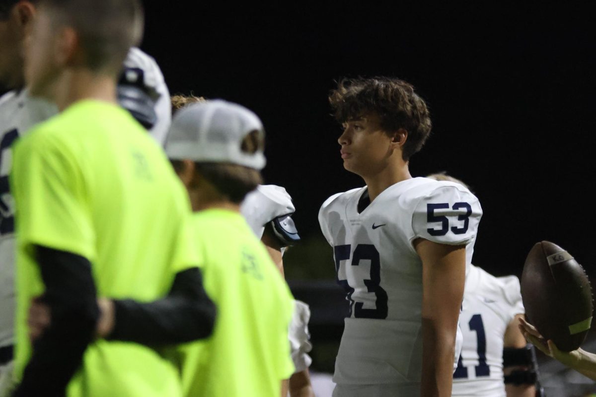 Staying focused, Sophomore Quinn Vaka watches the game.