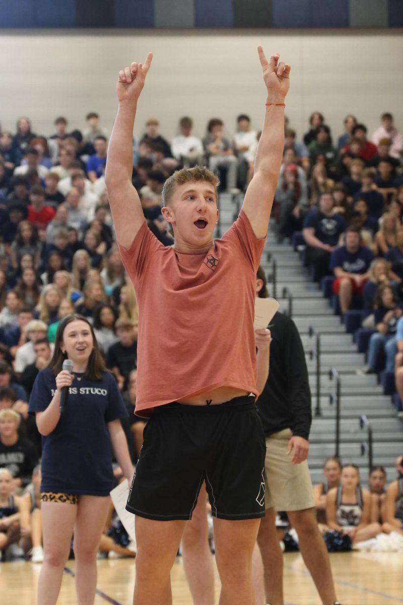 With both hands in the air, senior Hudson Powers celebrates after winning a round of the class game. 