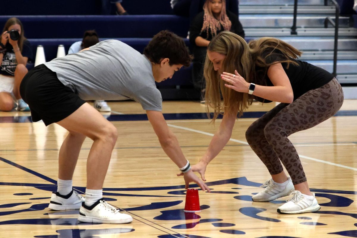 In the final round of the class game, “Head, Shoulders, Knees, Cup”, senior Noah Pham beats sophomore Gracyn Schreiber to the cup for the win.