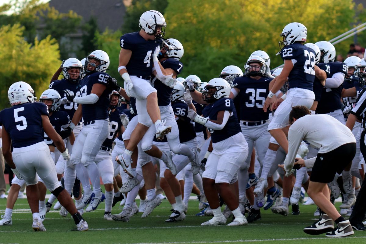 After the toss, senior Garret Clark jumps to his team.