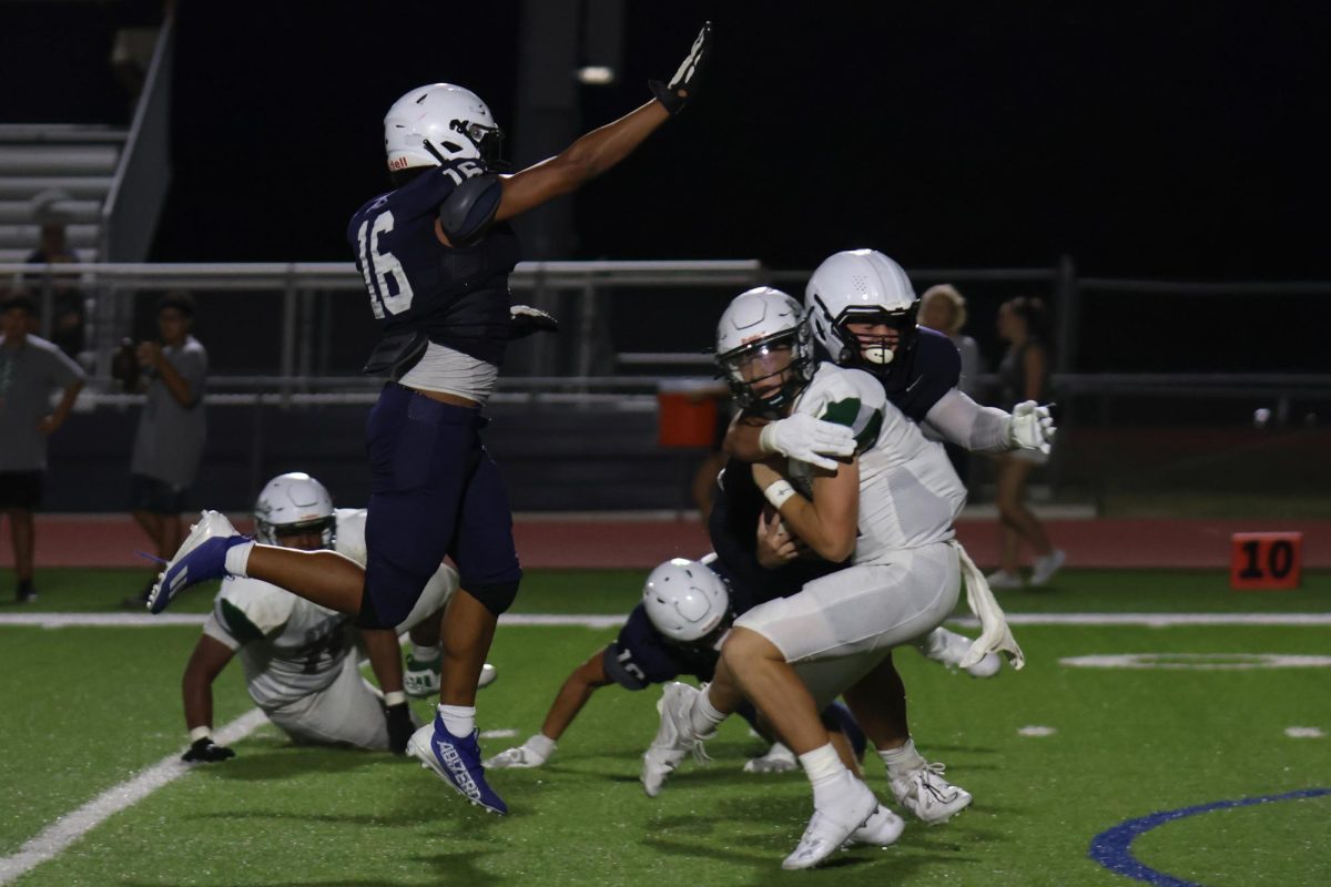 Going for the sack, sophomore Larry Jones and junior Hayden Heller tackle the opposing quarterback.
