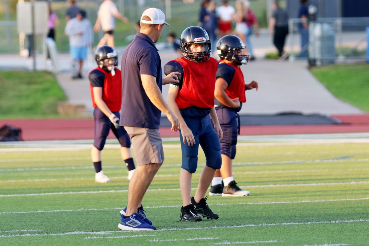 During the scrimmage, Junior Jag coach and player talk.