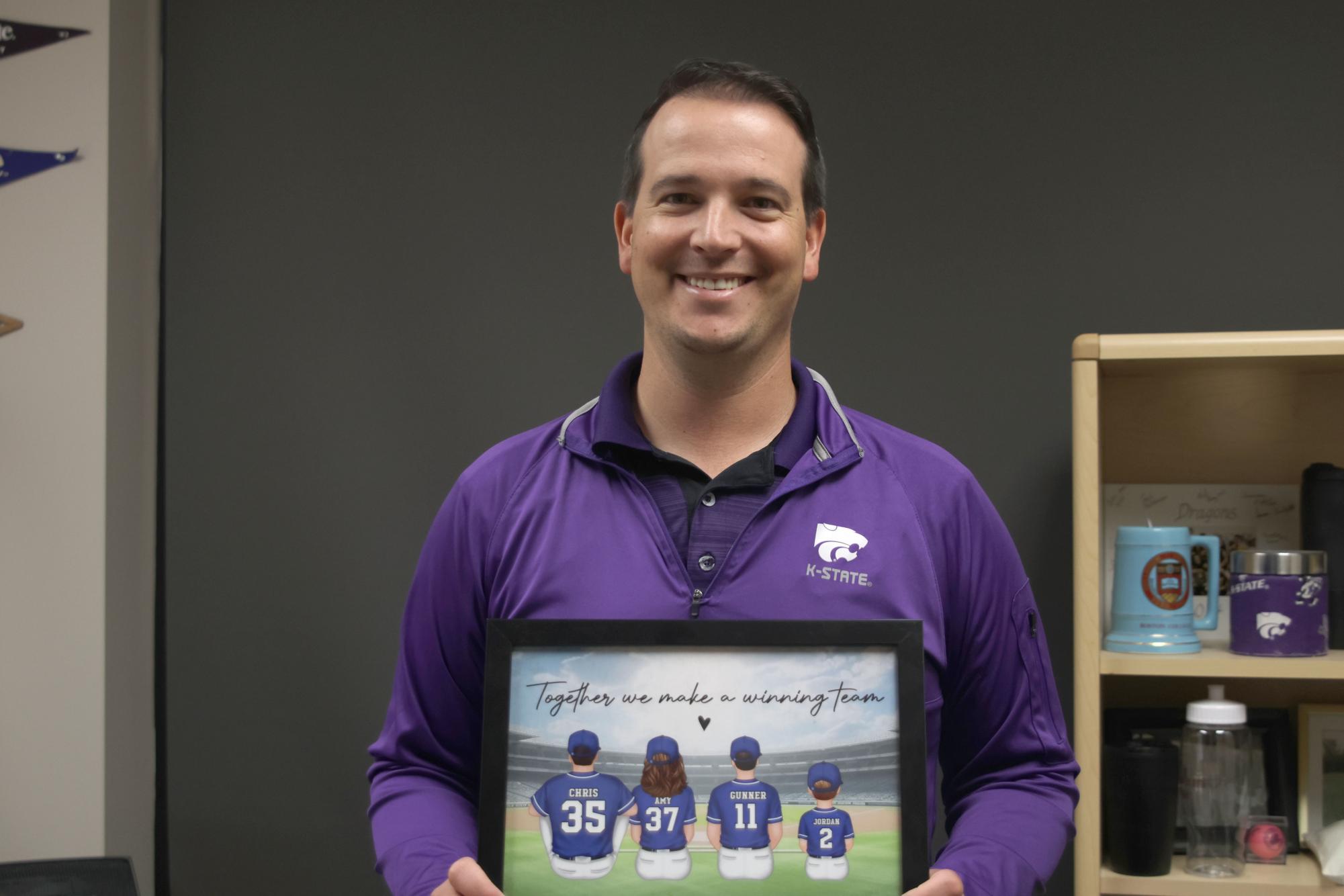 Counselor Chris Wallace holds a graphic of his family in his office to remind him of one of the reasons he comes to work everyday. 