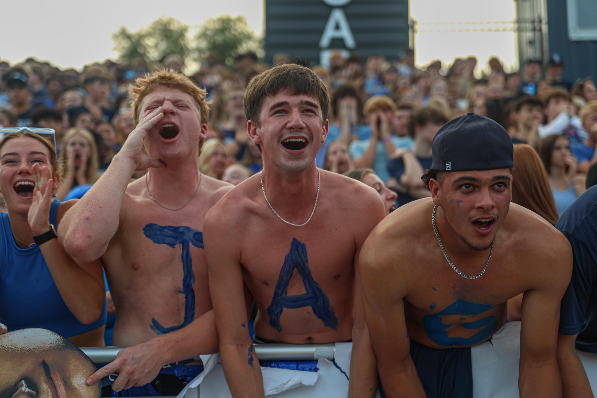 Yelling during the kickoff, seniors Conner Wood, Thatcher Ivey, and Jake Hobbs cheer on the football team.