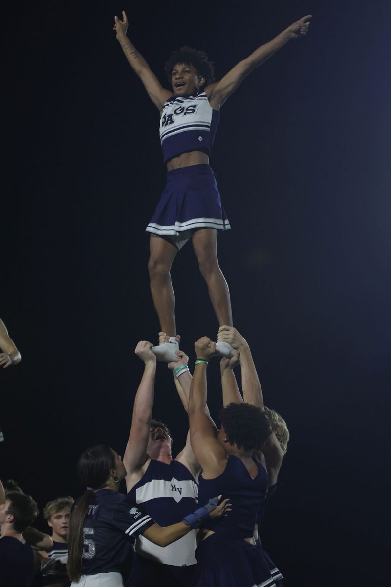 Junior Daniel Davis cheers in the air as juniors Drew Yockey, Drew Everhart and MJ Wash hold him up.
