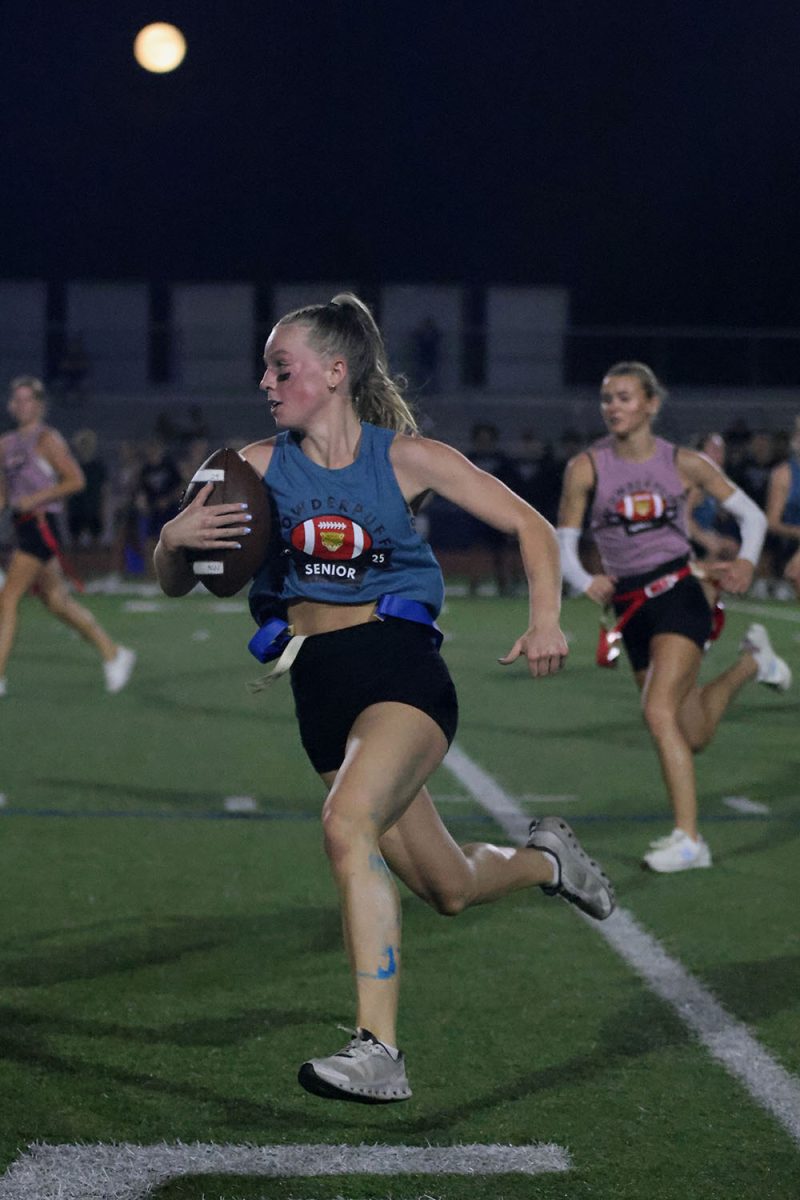 Senior Josie Benson runs with the ball in an attempt to score for the seniors.
