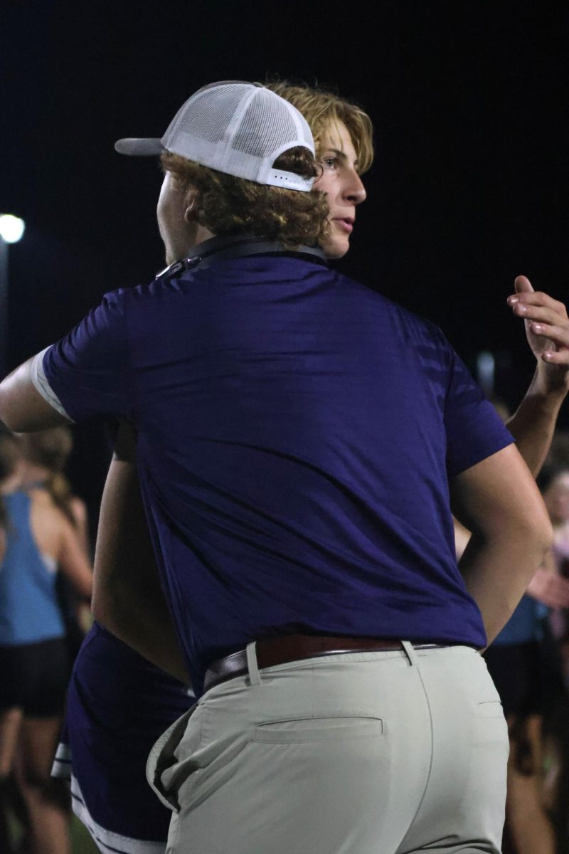 Senior Aiden Lehr and junior Dylan Everhart hug after the powderpuff game.