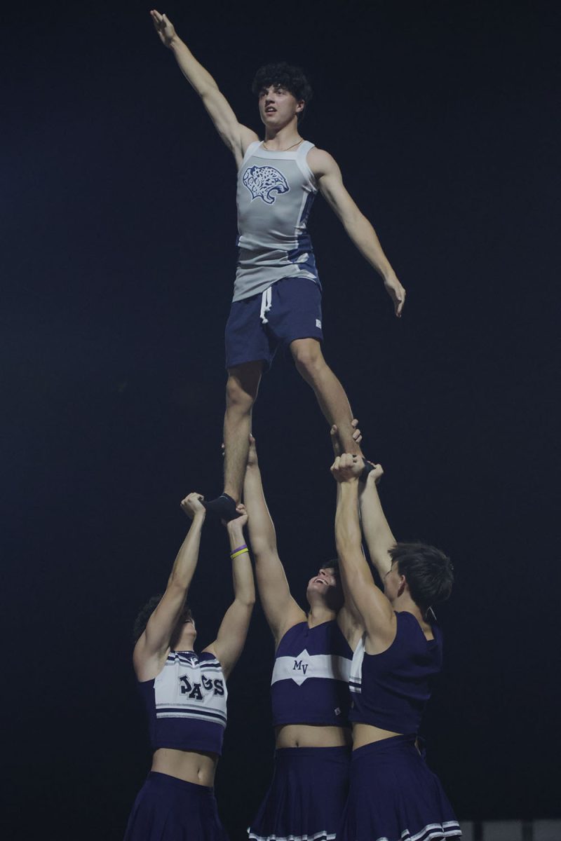 Juniors Max Fierro, Carter Crist, Jack Carpenter and Palmer Norman do a cheerleading stunt for the crowd.
