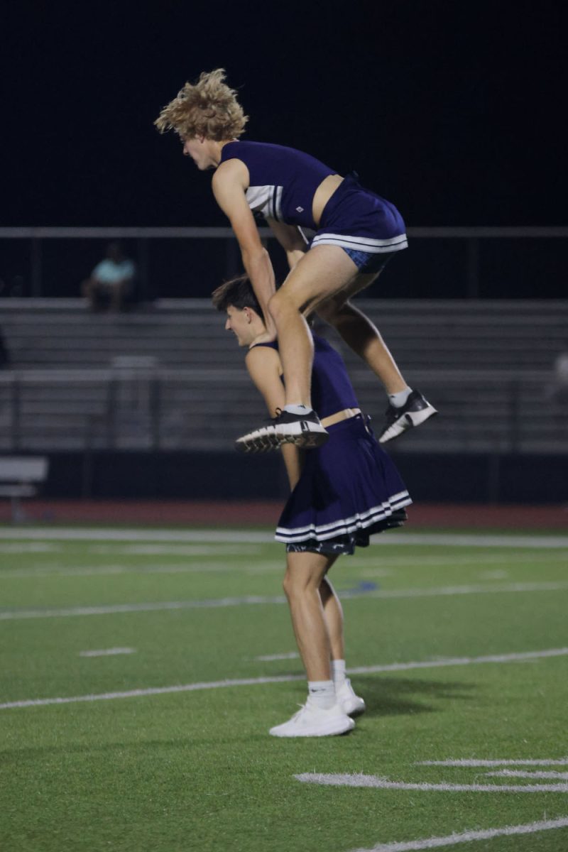 Junior Dylan Everhart jumps over junior Jack Carpenter after the junior team scored a touchdown.
