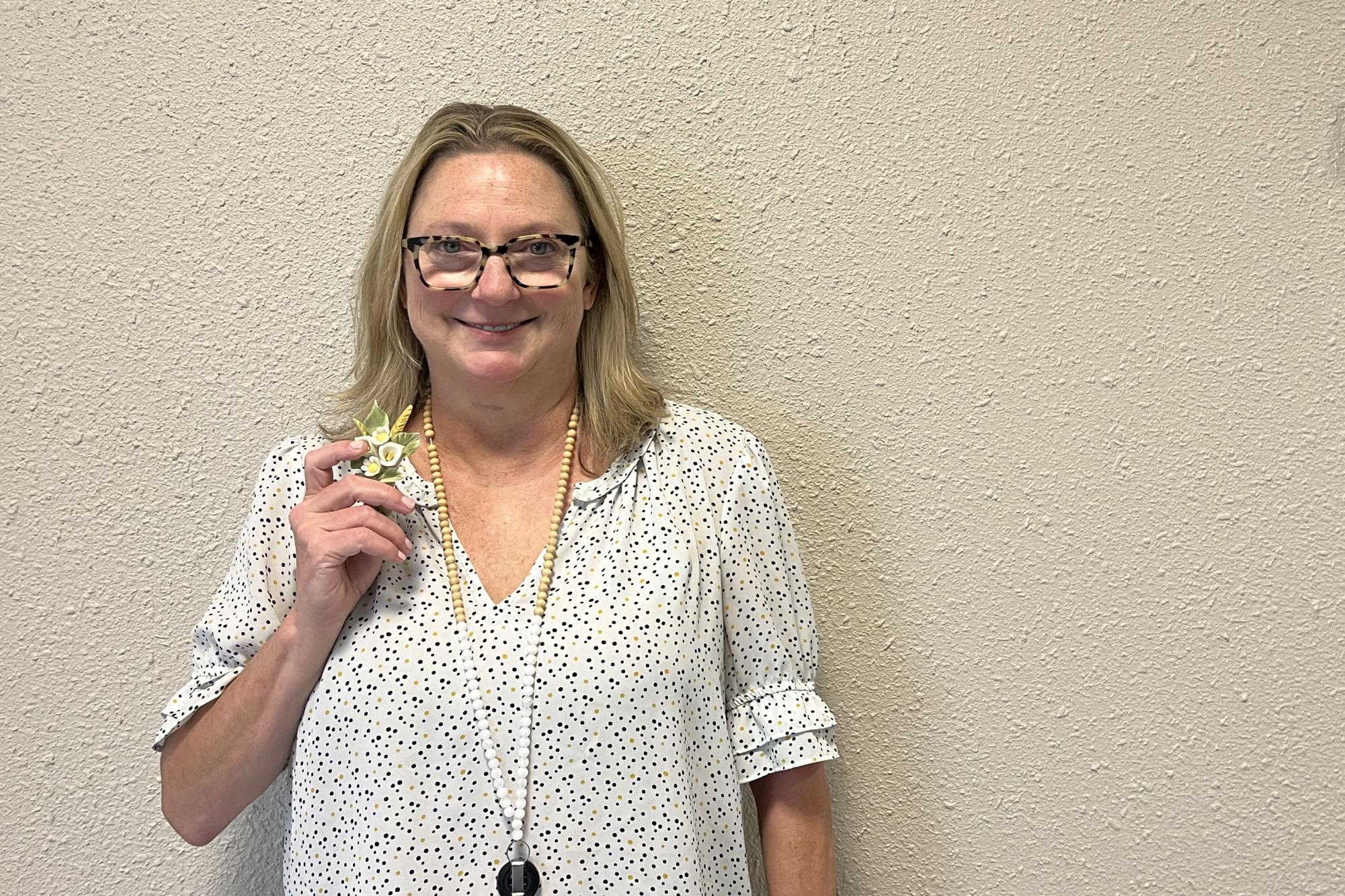 Social worker Jenny Munroe poses with a Japanese flower decoration gifted by a previous student. 
