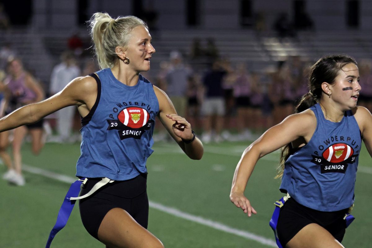 Eyes on her opponents, senior Mollie Smith runs across the field. 