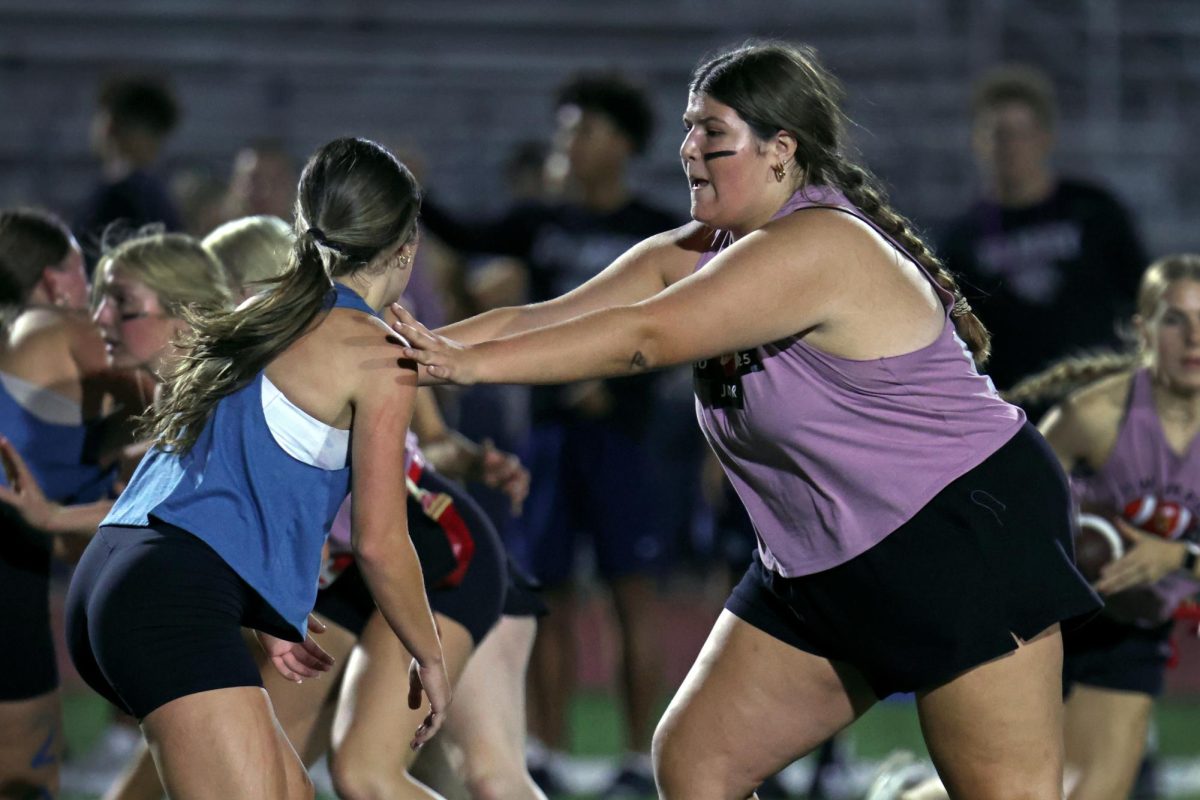 Arms out, junior Mackie Olson blocks her opponent.