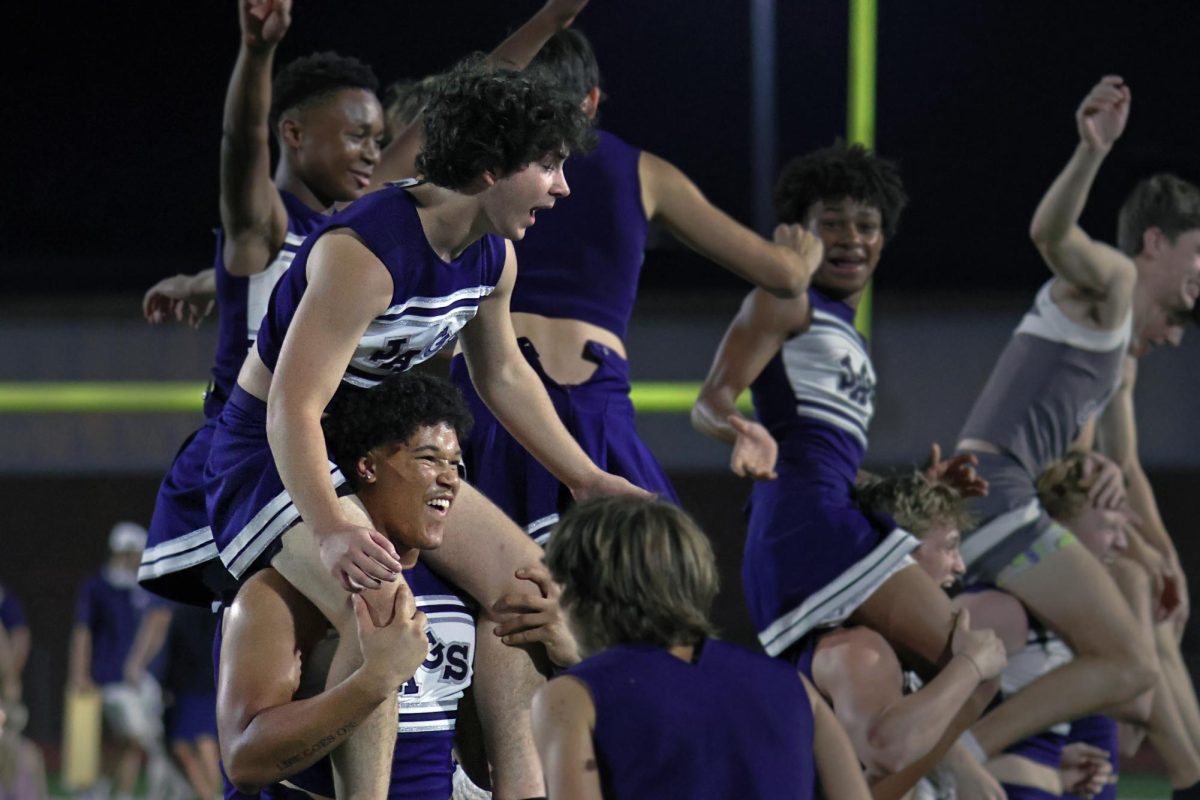 During the halftime show, junior MJ Wash holds up junior Lukas Isenberg on his shoulders.