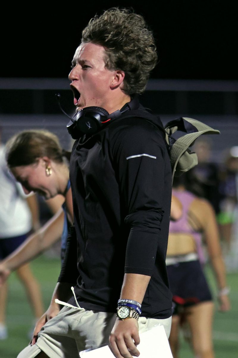 Yelling, senior Kye Jegen runs onto the field in celebration of the seniors scoring. 