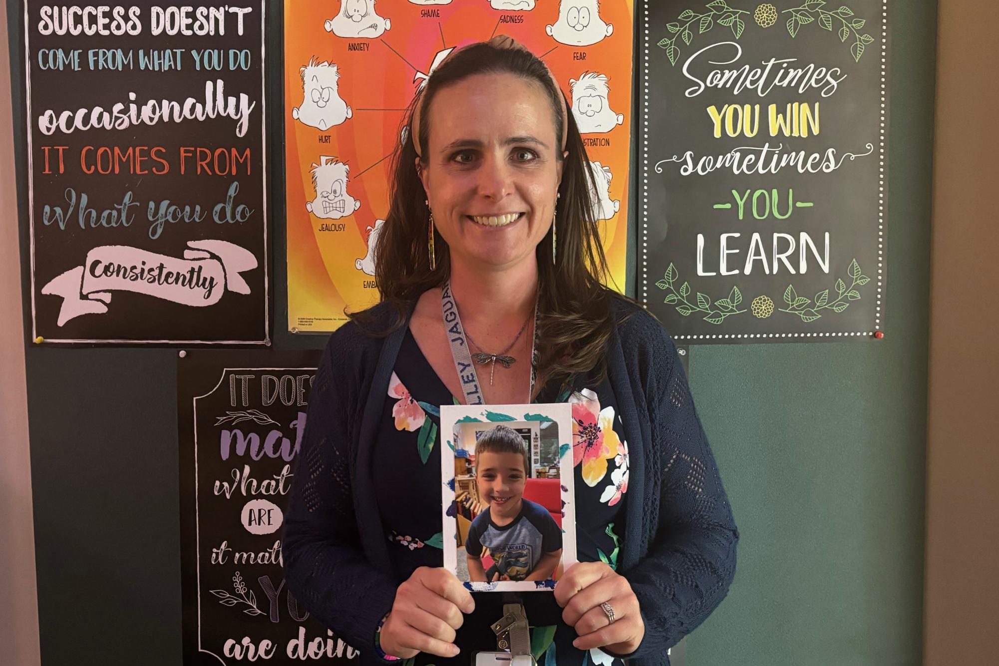 New social worker Katie Hess holds a picture of her son, which helps reground her when getting caught up with other people's problems. 