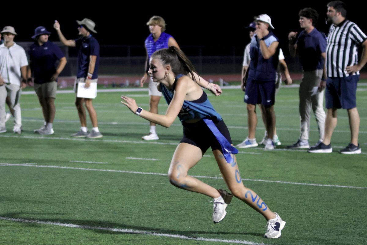 Running, senior Emery Chezem races across the field.
