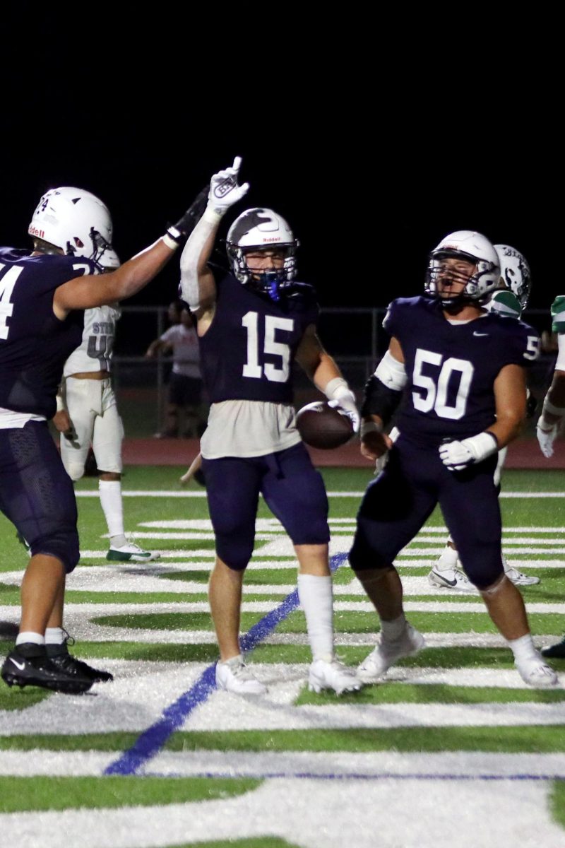 Senior Andy Watts celebrates with his teammates after a play.