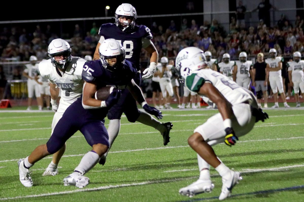 Senior Reggie Reece makes a run down the line with the ball.