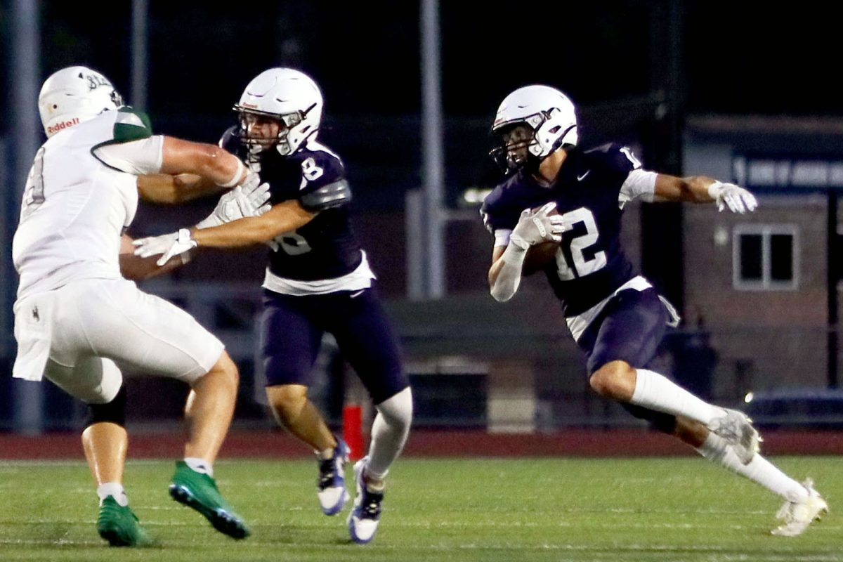 Junior Blake Jay runs down the field with the ball.