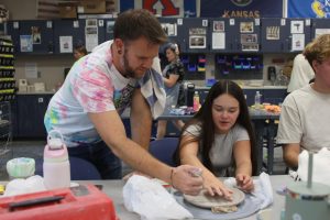 Ceramics teacher Brian Lloyd listens to Junior Annie Newell's question on Thursday, Oct. 17. 