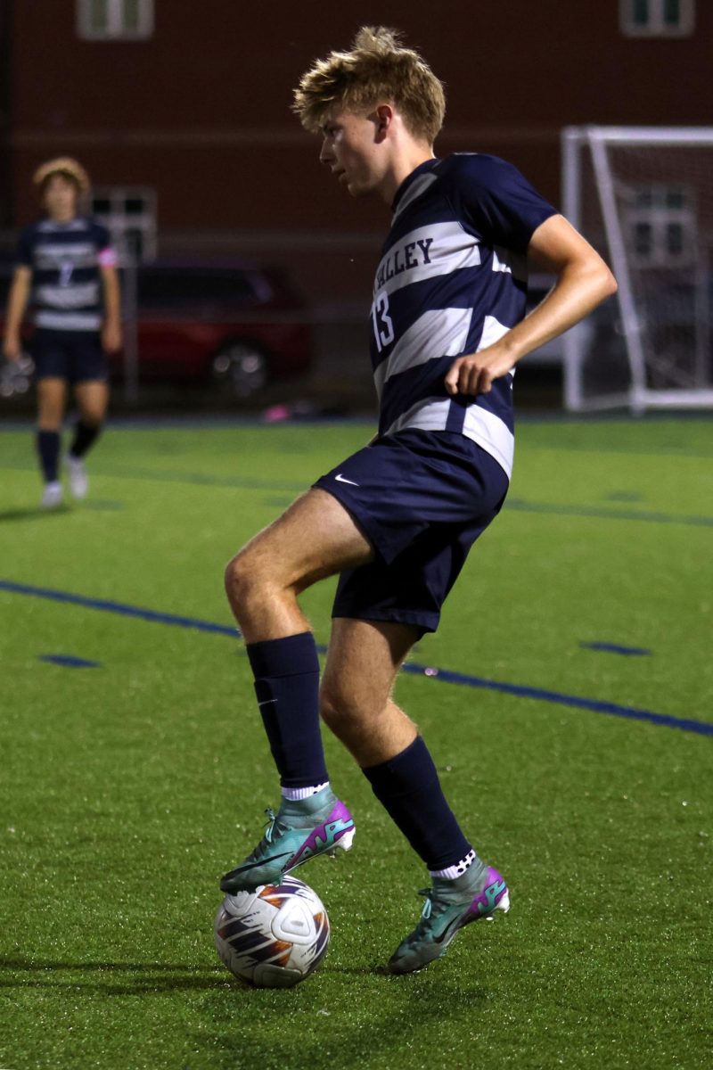 Foot on the ball, senior Drew Enloe looks to pass to a teammate.