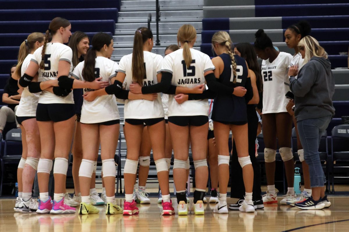 Team huddles before the last set of the game.