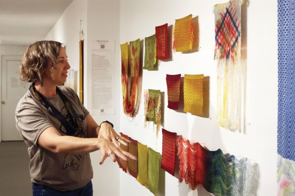 Artist Debbie Barrett- Jones explains the process she goes through to make her woven art that is displayed at the First Fridays event. Barrett  - Jones said, “I hand dye all my material then I weave it, then I do this thing of taking apart my work, after I have woven it I'll take some of it apart.”