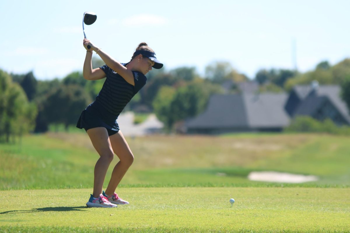 Eyes on the ball, junior Maddie Martin prepares to tee off. 
