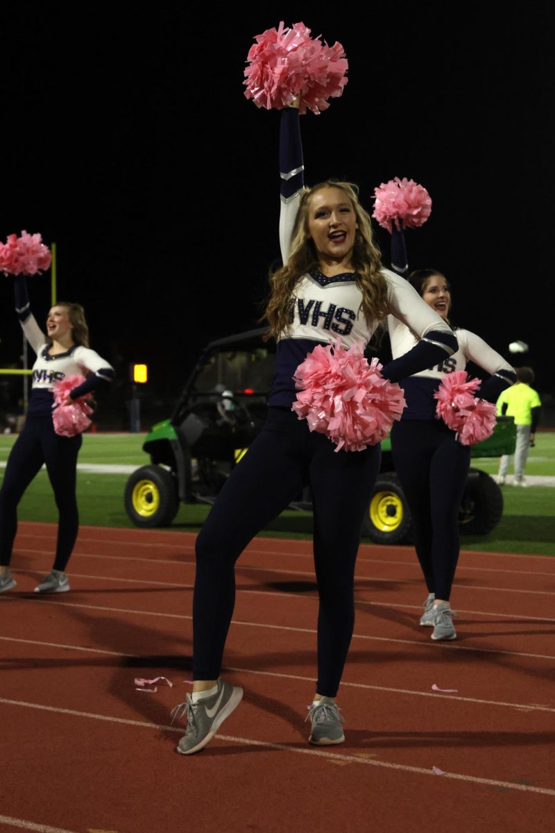 Moving together, sophomore Chloe Thomas and seniors Ashley Ayers and Hannah Weis perform a chant.
