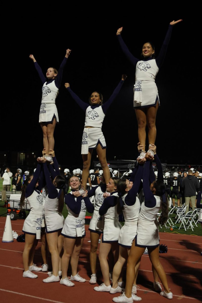 All together, the cheer squad works in tandem to form a pyramid on the sidelines.
