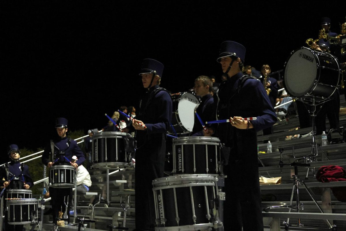 Looking at the drum major, seniors Sawyer Clark and Brendan Eyberg hit their drums in sync. 
