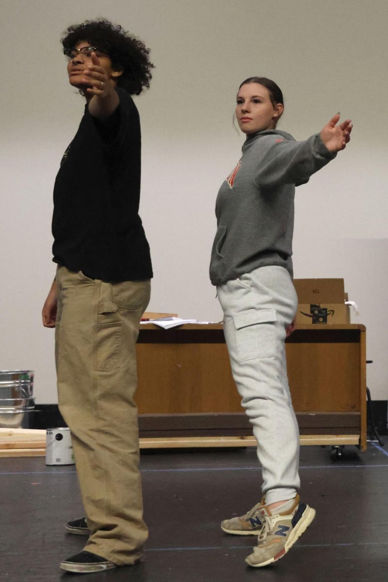 Juniors Ellyott Edwards and Lilly Gibson rehearse the opening number of the fall Repertory Theater musical.