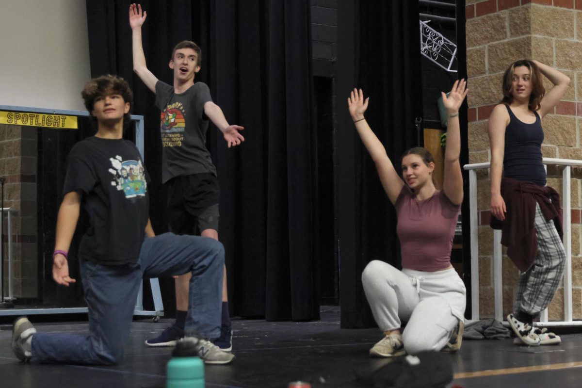 Posing, juniors Pete Williams, Lilly Gibson, Katie Davis, and senior Gabe Coleman review their choreography for the fall Rep Theater musical. 