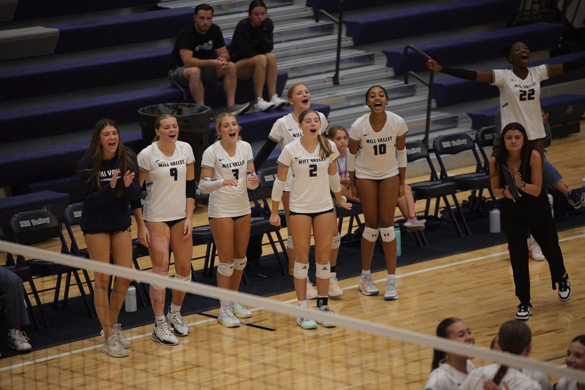 The team cheers on the sideline after the Jags score a point against Olathe Northwest Tuesday Oct. 1.