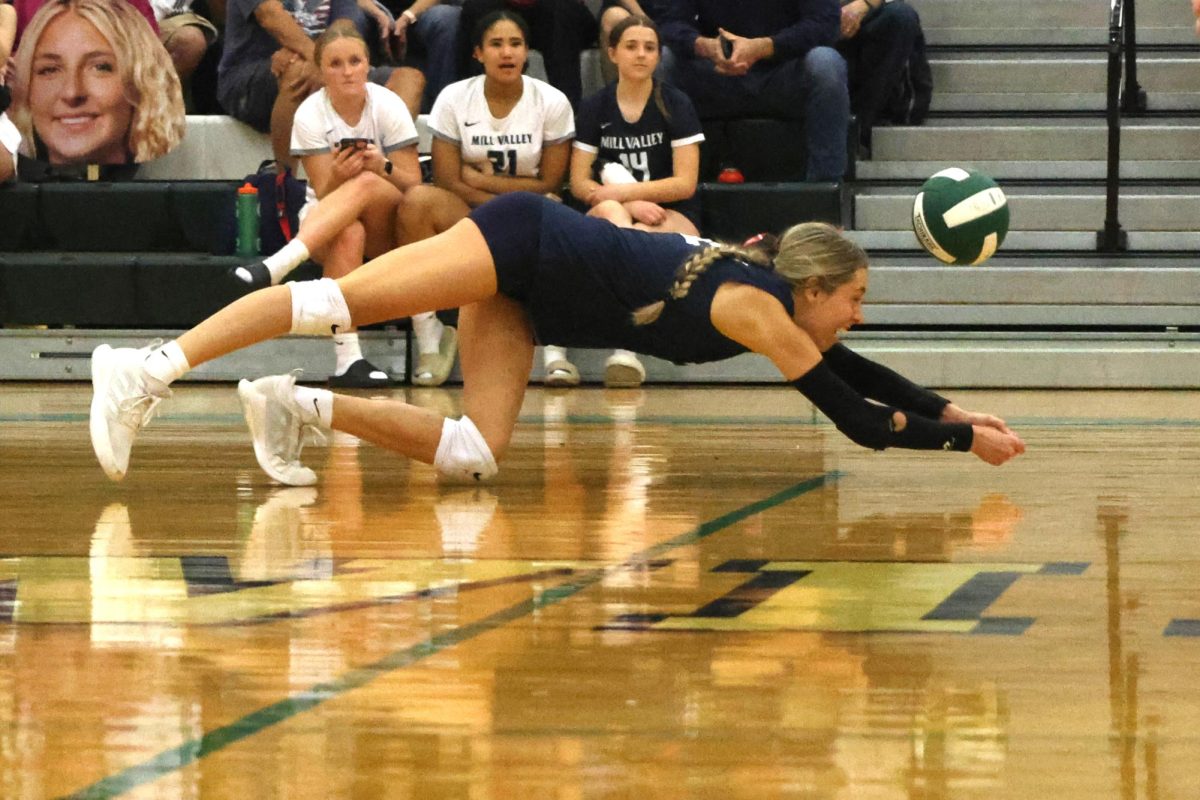 During the third set, junior Corinne Schwindt dives to save the ball.  
