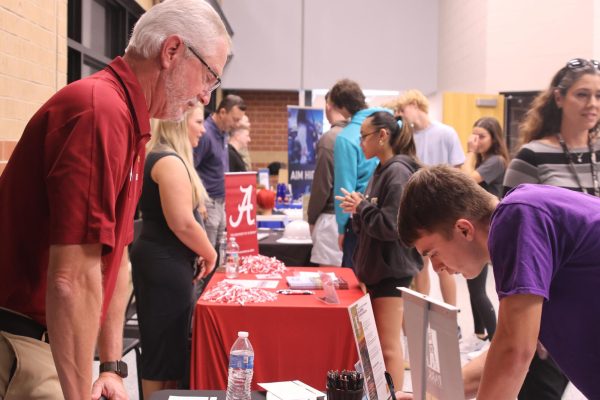 Senior James Haase gives his contact information to Park University.