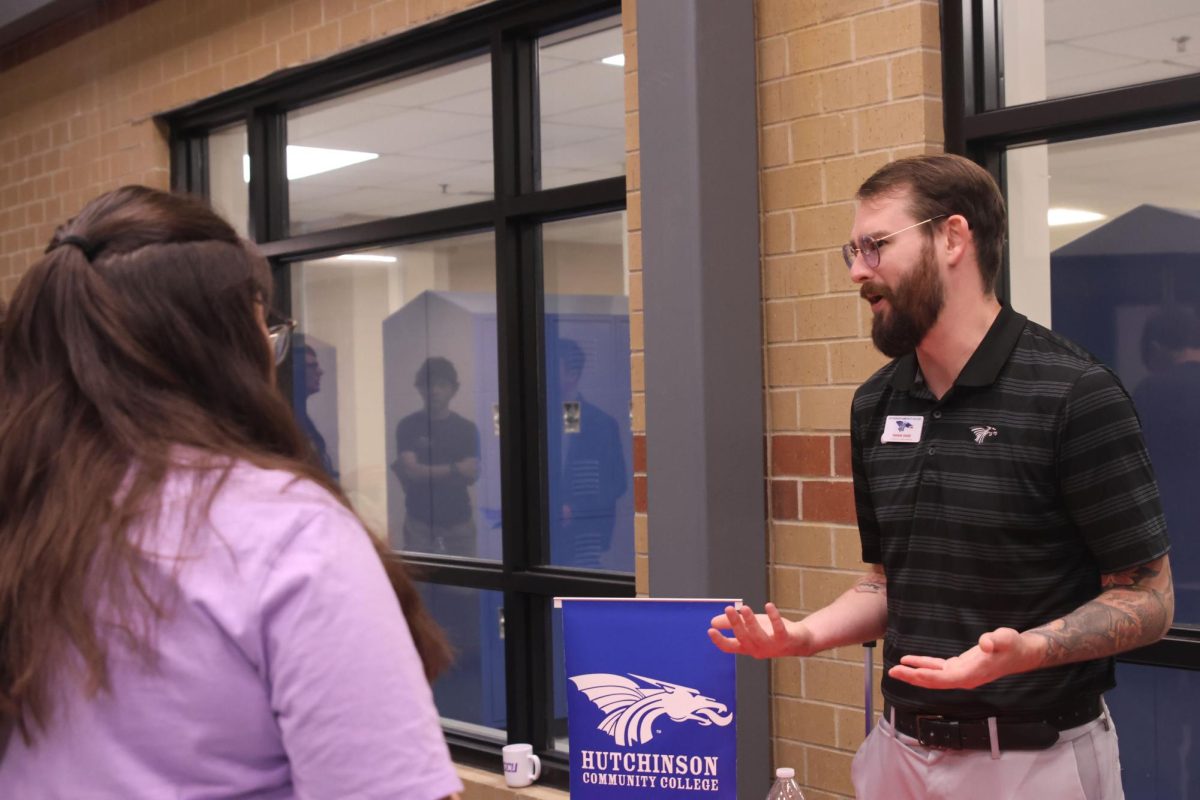 Senior Gillian Szymczak talks to a representative from Hutchinson Community College.