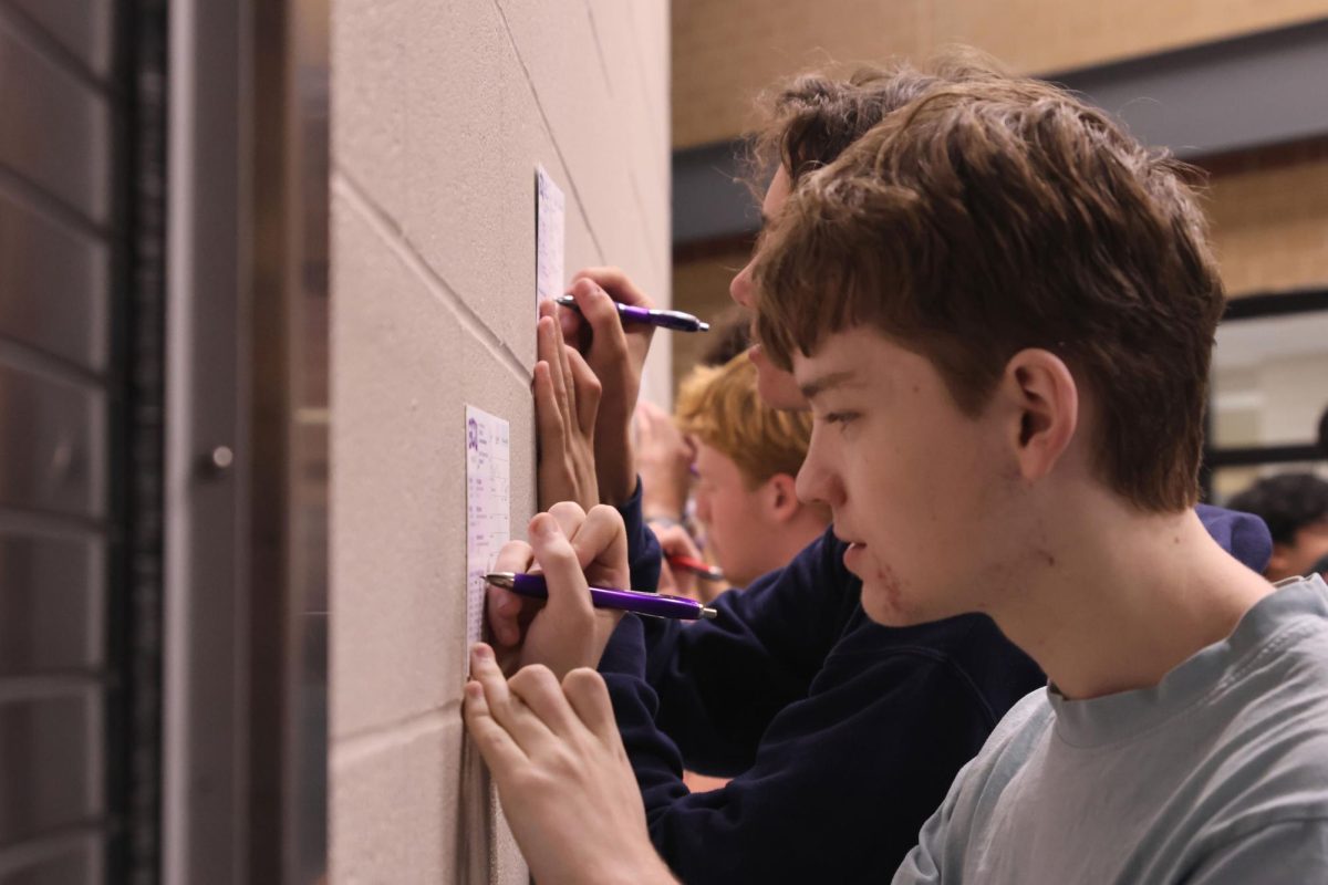 Juniors Harrison Guest and Ethan Culver fill out forms for Grand Canyon University.