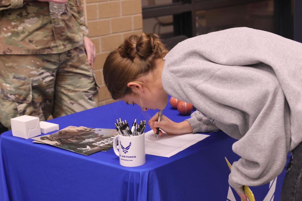 Junior Mae Reynolds offers her contact information to the U.S. Air Force.