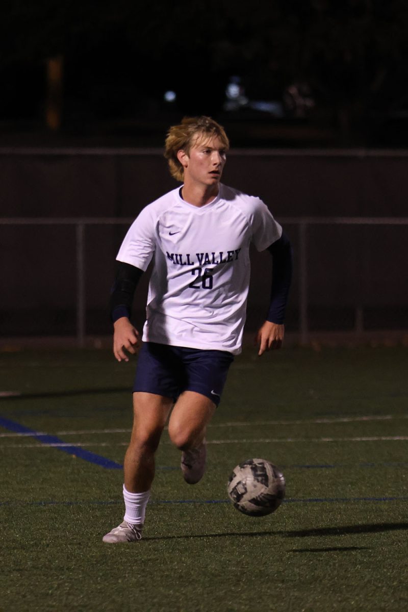 Searching, junior Kamden Dick looks for an open player to pass the ball to for a goal. 