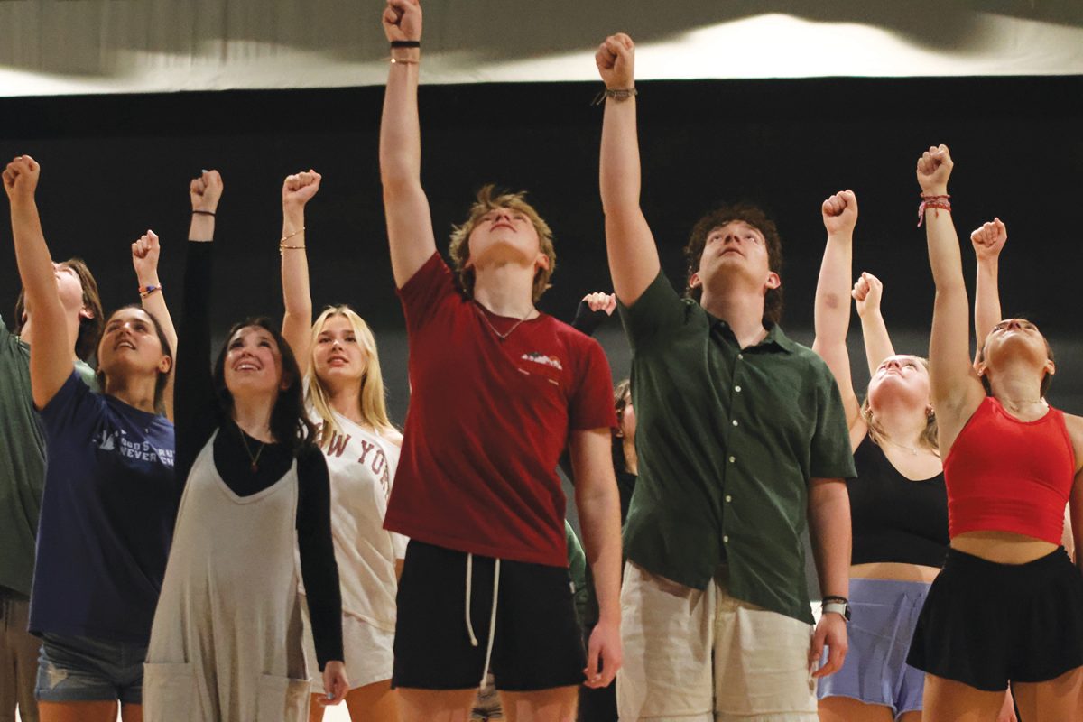 Hitting the final pose, the Footloose cast takes a breath after finishing a song. 