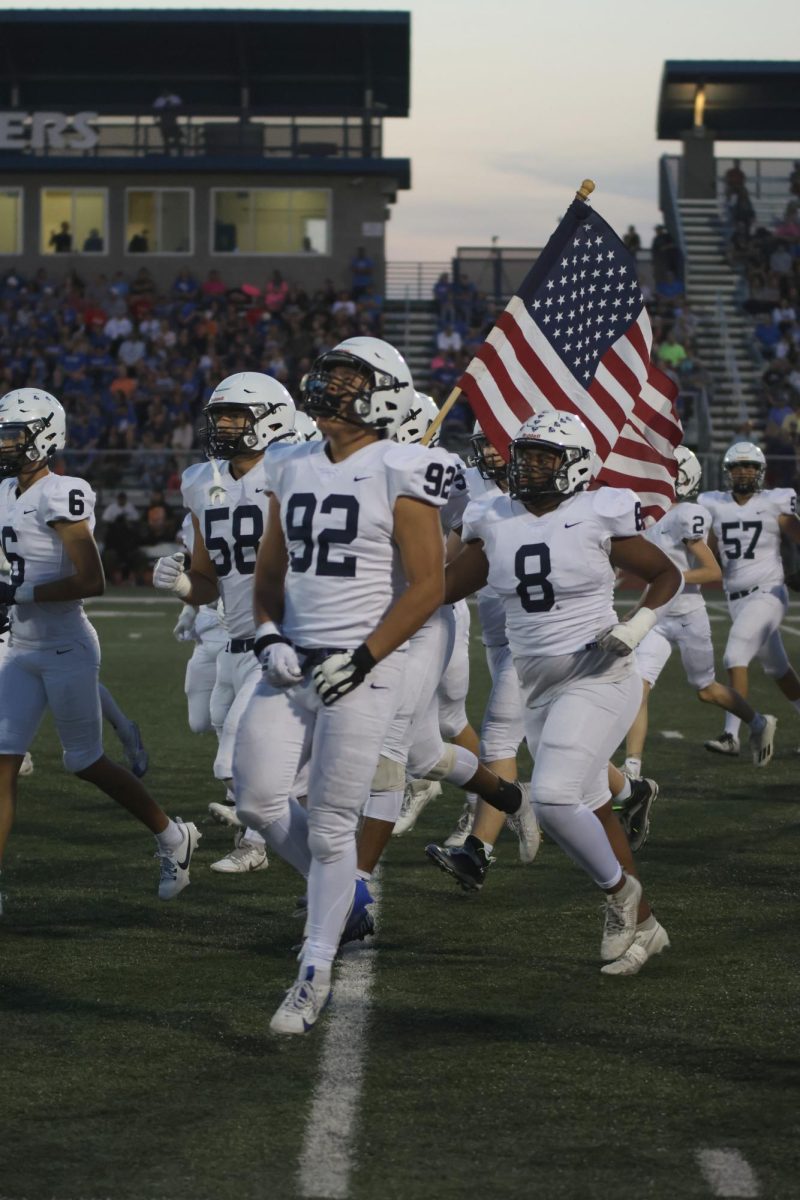 Excited for the game, sophomore Josh Garcia jumps while running to the sidelines. 