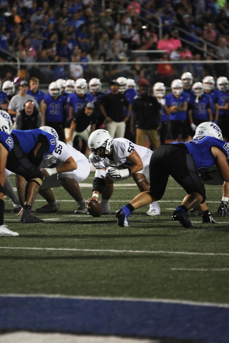 Setting up the play, senior Zach Zaldivar gets ready to snap the ball. 