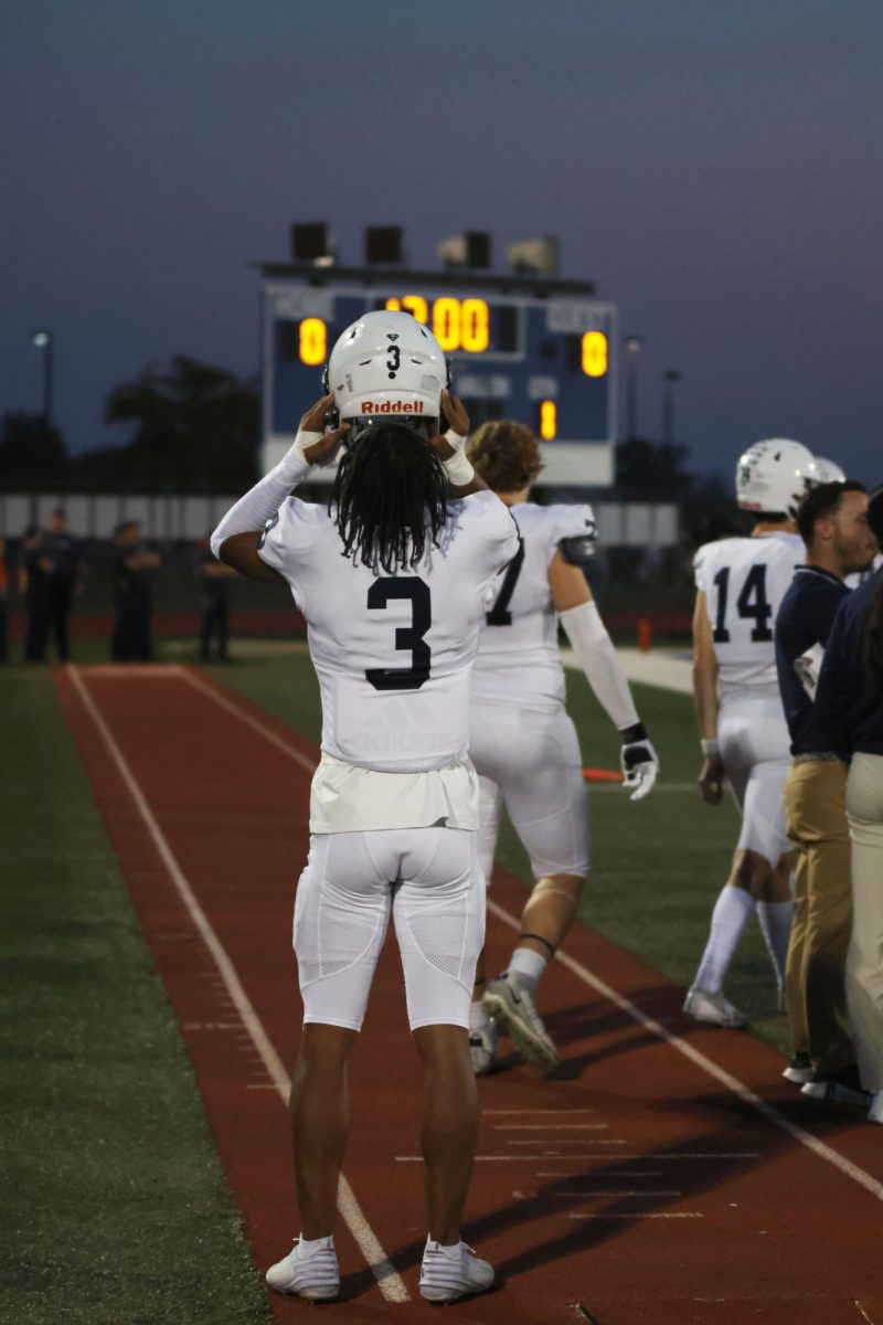 Senior Desmon Williams adjusts his helmet before getting ready to play. 