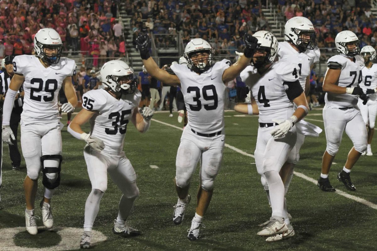 Celebrating a recovered fumble, sophomore Ryder Farley rejoices with teammates. 