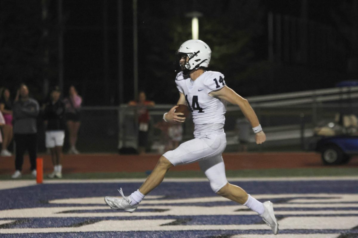 Running the ball into the endzone, senior Connor Bohon scores a touchdown. 